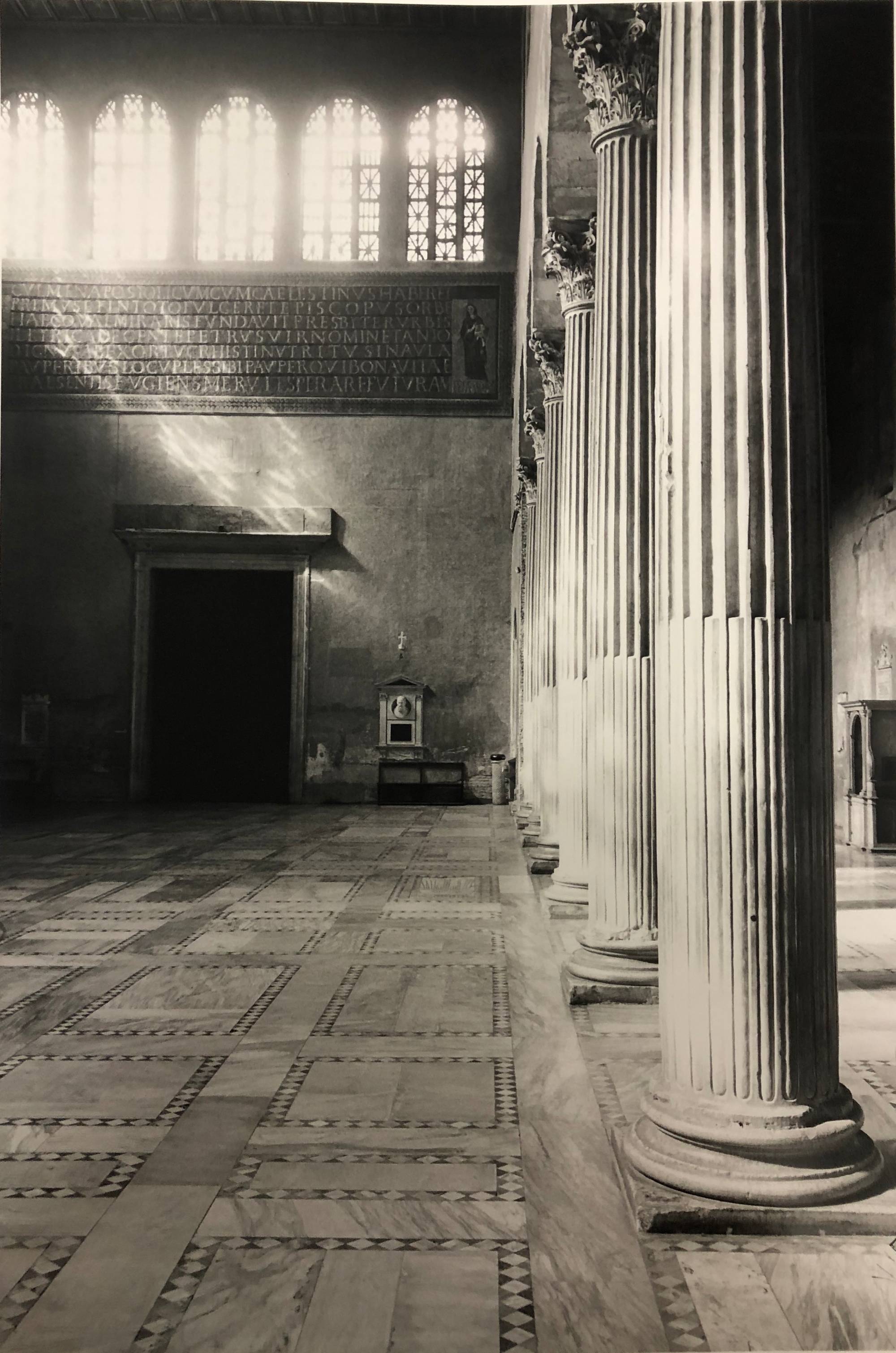 black and white photo of white columns inside cathedral